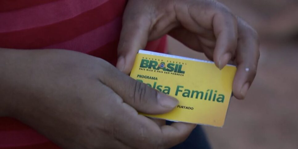 Pessoa segurando cartão do Bolsa Família (Foto: Reprodução / Globo)