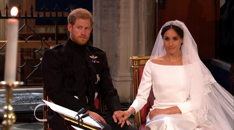 Príncipe Harry e a atriz Meghan Markle durante o casamento (Foto: Reprodução/Globo)